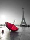 Two umbrellas next to the Eiffel tower Art Print