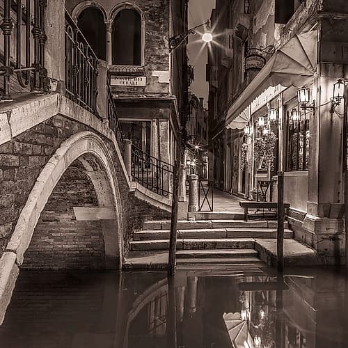 Night shot of cafe by narrow canal-Venice-Italy Art Print