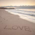 Love - word written on sand at the beach Art Print