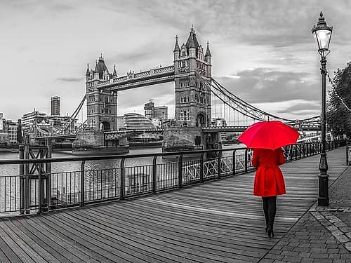 Tourist with red umbrella on promenade near Tower bridge, London, UK Art Print