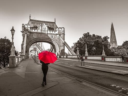 Tourist with umbrella on Tower Bridge, London, UK Art Print