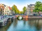 Canal through Amsterdam city Art Print
