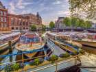 Boats moored in the Canal through Amsterdam city Art Print
