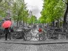Woman with umbrella by the canal, Amsterdam Art Print