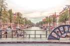 Canal through Amsterdam city Art Print