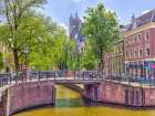 Canal through Amsterdam city Art Print
