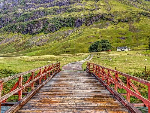 Wooden bridge over water stream at Glen Coe valley-Scotland Art Print