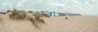 Beach huts on sandy seashore Art Print