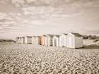 Beach huts on sandy seashore Art Print