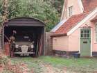 Classic car in garage of old house Art Print