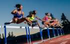 Athletes Race Over Hurdles On A Track At Dusk, Displaying Strength And Determination. Wa, USA Art Print
