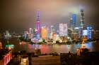 Shanghai Skyline Illuminated At Night With Colorful Lights And A Cloudy Sky. Shanghai, China Art Print