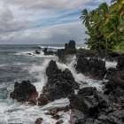 Rugged Black Volcanic Rocks On A Lush Tropical Coastline With Waves Crashing. Haiku, Hawaii, USA Art Print