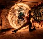 Woman Performing Fire Spinning In A Graffiti-Covered Urban Setting. Wa, USA Art Print