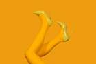 Womans Legs In Yellow Tights And High Heels On Yellow Background Art Print by Alena A