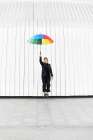 Businesswoman With Colorful Umbrella In Front Of Modern Architecture Art Print