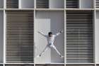 Man Jumping In Front Of Modern Urban Building In Barcelona Art Print
