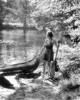 1930S Young Woman Wearing Bathing Costume Shorts Halter Top Barefoot Hand On Front Of Canoe Lake Art Print
