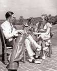 1930S Couple Man And Woman Sitting On Patio Each With Golf Bag And Clubs Talking About Game Clothes Art Print