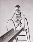 1940S Boy At Top Of Playground Slide Pushing Up On Hand Rails Crossing His Legs Funny Expression Art Print