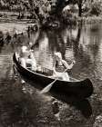 1930S Couple Man And Woman Paddling A Canoe Going On A Summer Picnic With Basket And Thermos Art Print
