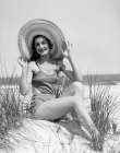 1920S 1930 Smiling Bathing Beauty Wearing Straw Hat Sitting On Beach Sand Dune Looking At Camera Art Print