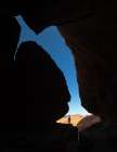 A Young Man Stands In A Cave Looking Out Towards The Desert Outside In Wadi Rum, Jordan. Art Print