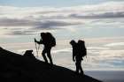 Hikers Ascend A Ridge Above Sorvagen, Moskenesoya, Lofoten Islands, Norway. Art Print