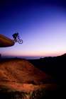 Low Angle View Of Young Man Jumping His Mountain Bike Off Water Storage Tower Near Santa California. Art Print