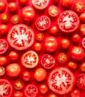 Top View Of Many Whole And Cut Tomatoes On Red Background. Art Print