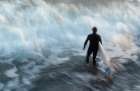 A Surfer Wades Into A Wave In Santa Barbara, California. (Blurred Motion) Art Print