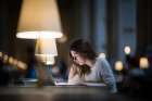 Focused Female Student Studying Late At Night In Library Art Print