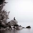 Young Man Sits On A Large Rock On The Shore Of Lake Sebago Near Portland, Maine (Black And White) Art Print