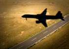 The Shadow Of An Airliner Crosses An Empty Road As It Approaches The Runway. Art Print