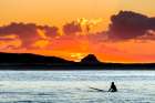 A Surfer Waits For A Wave At Sunset. Art Print