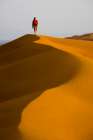Male Hiking In Red / Orange Sand Dunes In Desert. Art Print
