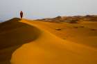 Male Hiking In Red / Orange Sand Dunes In Desert. Art Print