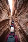 Hikers Squeeze Up The Narrow Little Wild Horse Canyon, San Rafael Swell, Utah. Art Print
