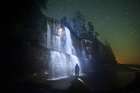 A Backpacker Stands Facing Tsusiat Falls At Night, West Coast Trail, British Columbia, Canada. Art Print