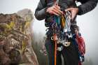 A Young Man Sorts Nuts And Cams On A Climb Of The First Flatiron Above Boulder, Colorado. Art Print