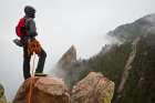 Young Man Looks Out Towards Flatirons, Shrouded In Mist, From Summit Of First Flatiron Colorado. Art Print