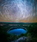 Circumpolar Star Trails Over Mountain Lagoon With Reflections In Water Art Print
