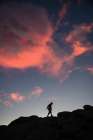 Adventurer Silhouette Against A Dramatic Sunset: Explore The Beauty Of Natures Evening Colors Art Print