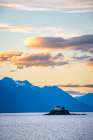 Explore Majestic Coastal Beauty: Breathtaking Lighthouse Against Stunning Mountain Backdrop Sunset Art Print