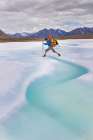 Backpacker Steps Over Water Melting On Aufeis Of Ribdon River In Arctic National Wildlife Alaska. Art Print