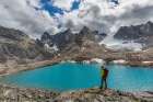 Man Pauses While Hiking At Edge Of Blue Lake In Arrigetch Peaks, Valley Of Aquarius, Gates Of Alaska Art Print