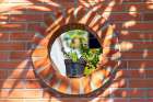 Mexico, Nayarit, Bahia De Banderas, Nuevo Vallarta. Brick Wall, Plant In Circular Opening. Art Print