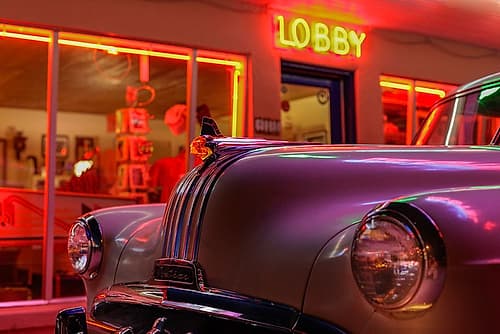 Tucumcari,New Mexico. Famous Blue Swallow Motel On Route 66 With Old Car Parked In Front. Art Print
