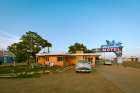 Tucumcari,New Mexico. Famous Blue Swallow Motel On Route 66 With Old Car Parked In Front. Art Print