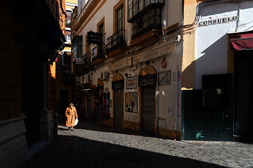 Woman in City Sunlight Art Print by Rosa Blanco
